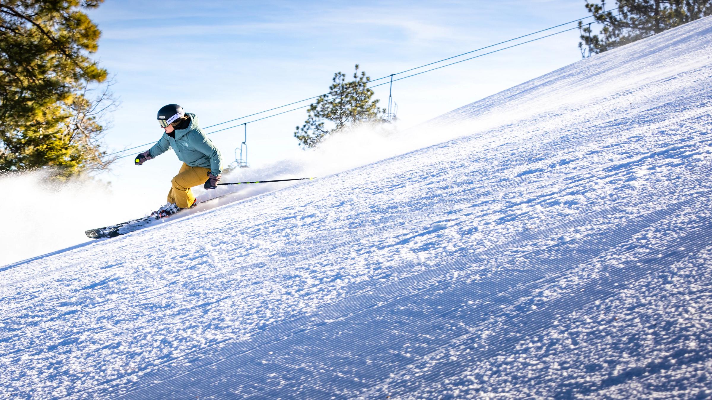 skier going downhill on a ski slope in big bear